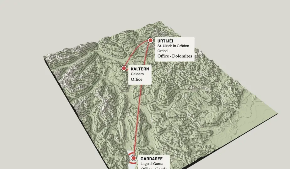 Still: rising above the peaks; lines connect the office in Urtijëi to Kaltern / Caldaro and Lake Garda.